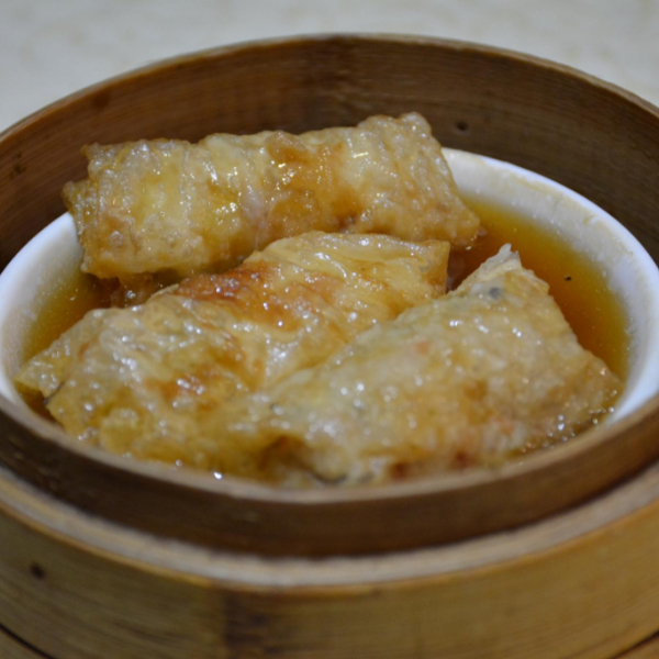 A plate of chinese dim sum, beancurd skin roll